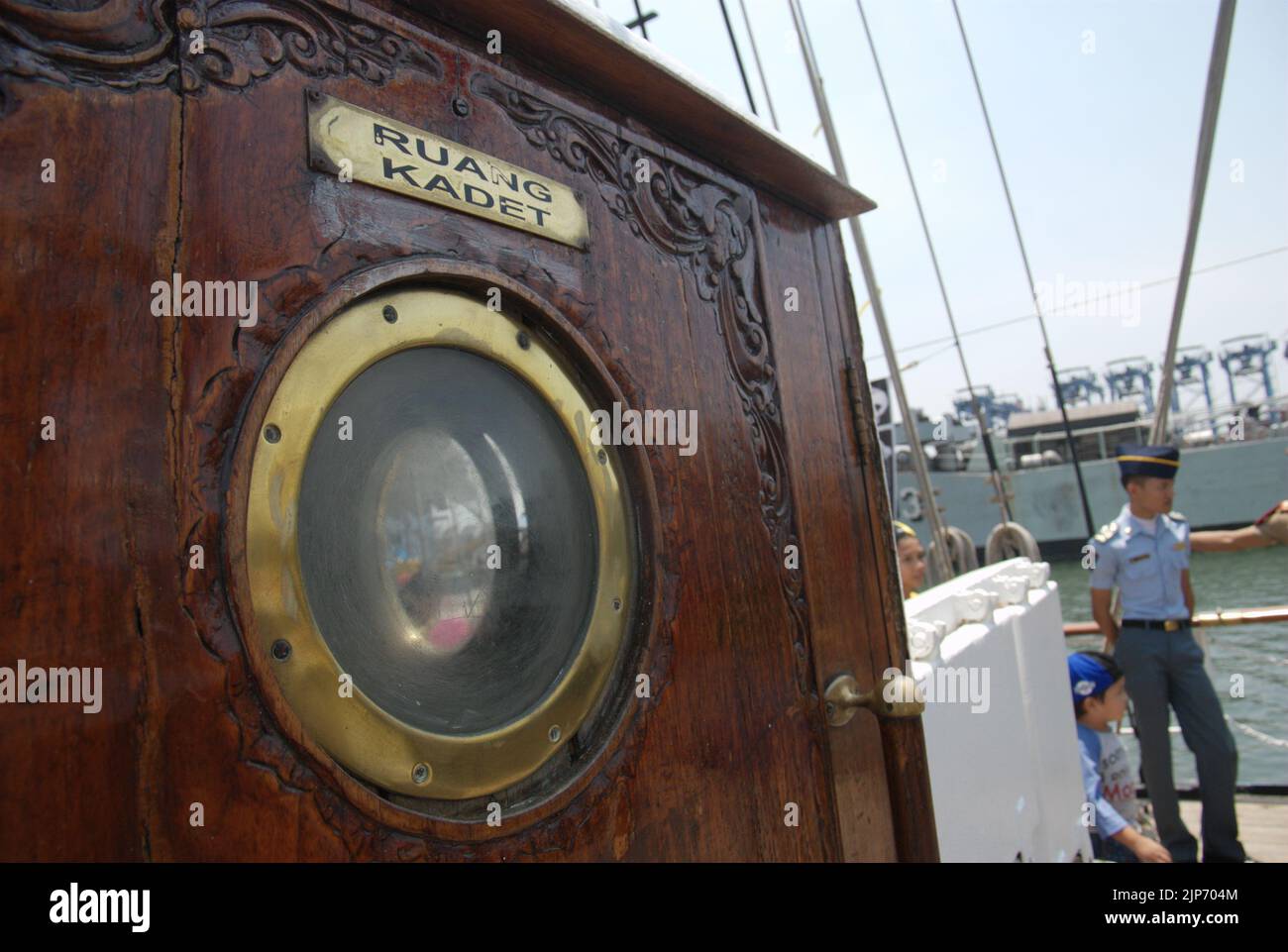 Rounded window glass on the door of cadet room on KRI Dewaruci (Dewa Ruci), an Indonesian tall ship, as the barquentine type schooner is opened for public visitors at Kolinlamil harbour (Navy harbour) in Tanjung Priok, North Jakarta, Jakarta, Indonesia. Stock Photo