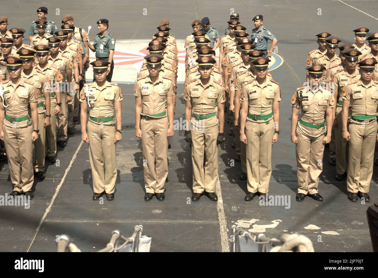 Indonesian navy cadets and officers lining up for a ceremony and briefing, as KRI Dewaruci (Dewa Ruci), an Indonesian tall ship, is opened for public visitors at Kolinlamil harbour (Navy harbour) in Tanjung Priok, North Jakarta, Jakarta, Indonesia. Stock Photo
