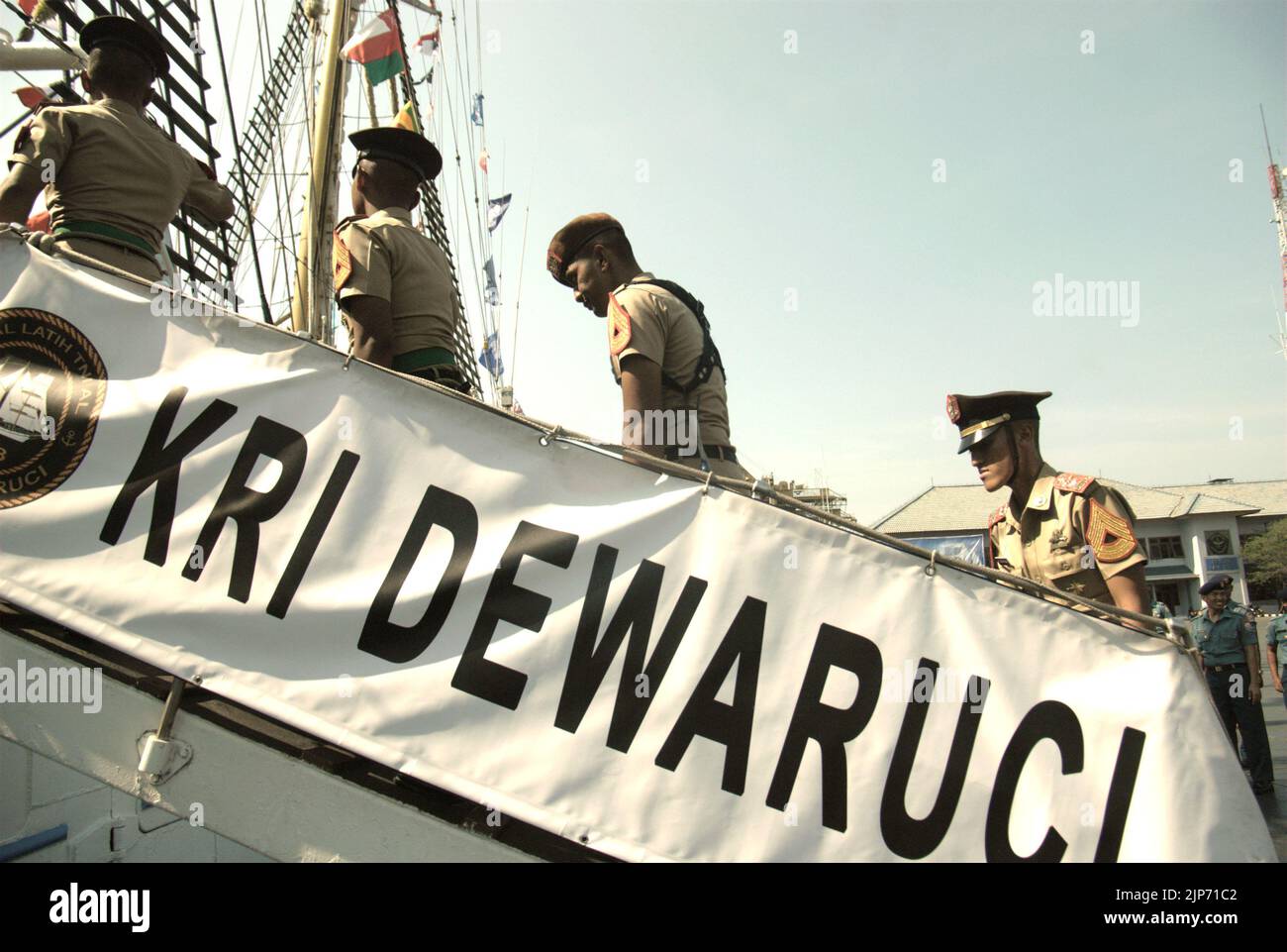 Indonesian navy cadets walking on the ladder to get onto KRI Dewaruci (Dewa Ruci), an Indonesian tall ship, as the barquentine type schooner is opened for public visitors at Kolinlamil harbour (Navy harbour) in Tanjung Priok, North Jakarta, Jakarta, Indonesia. Stock Photo