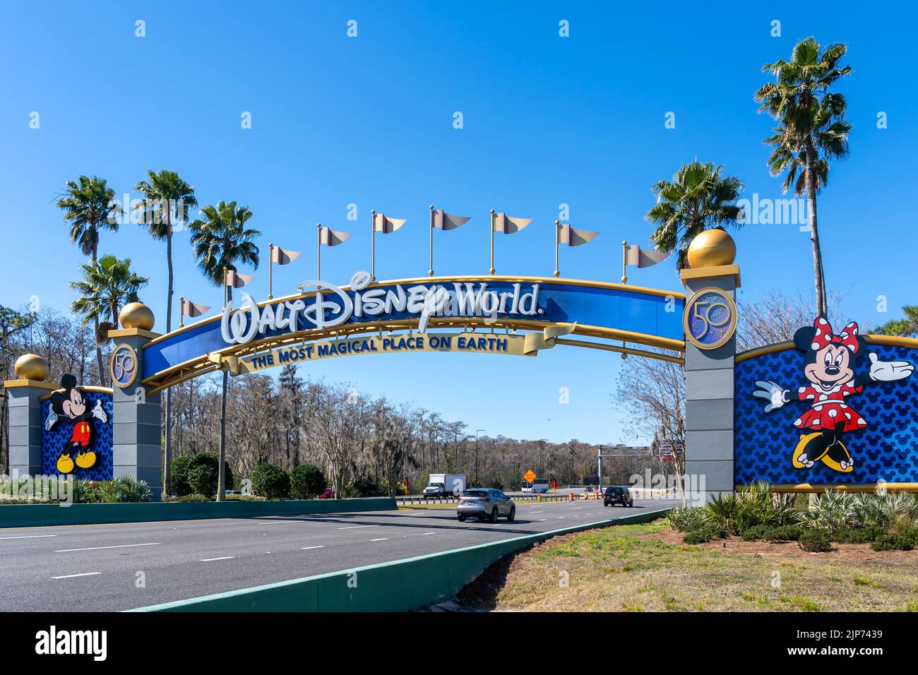 Orlando, Florida, USA - February 9, 2022:  A Walt Disney World arch gate on the road in Orlando, Florida, USA. Walt Disney World is an entertainment r Stock Photo