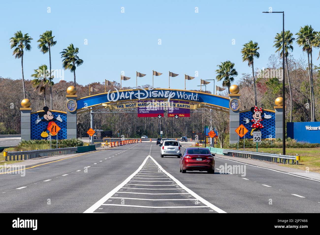 Orlando, Florida, USA - February 9, 2022:  A Walt Disney World arch gate on the road in Orlando, Florida, USA. Walt Disney World is an entertainment r Stock Photo