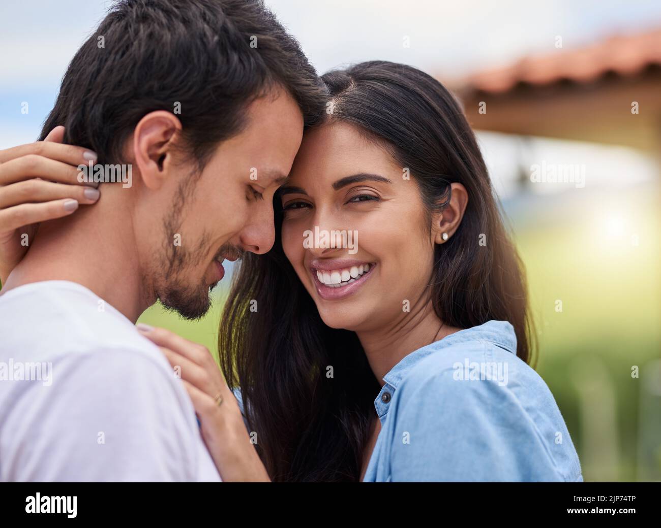 Hes the man of my dreams. an affectionate young couple embracing while standing outdoors. Stock Photo