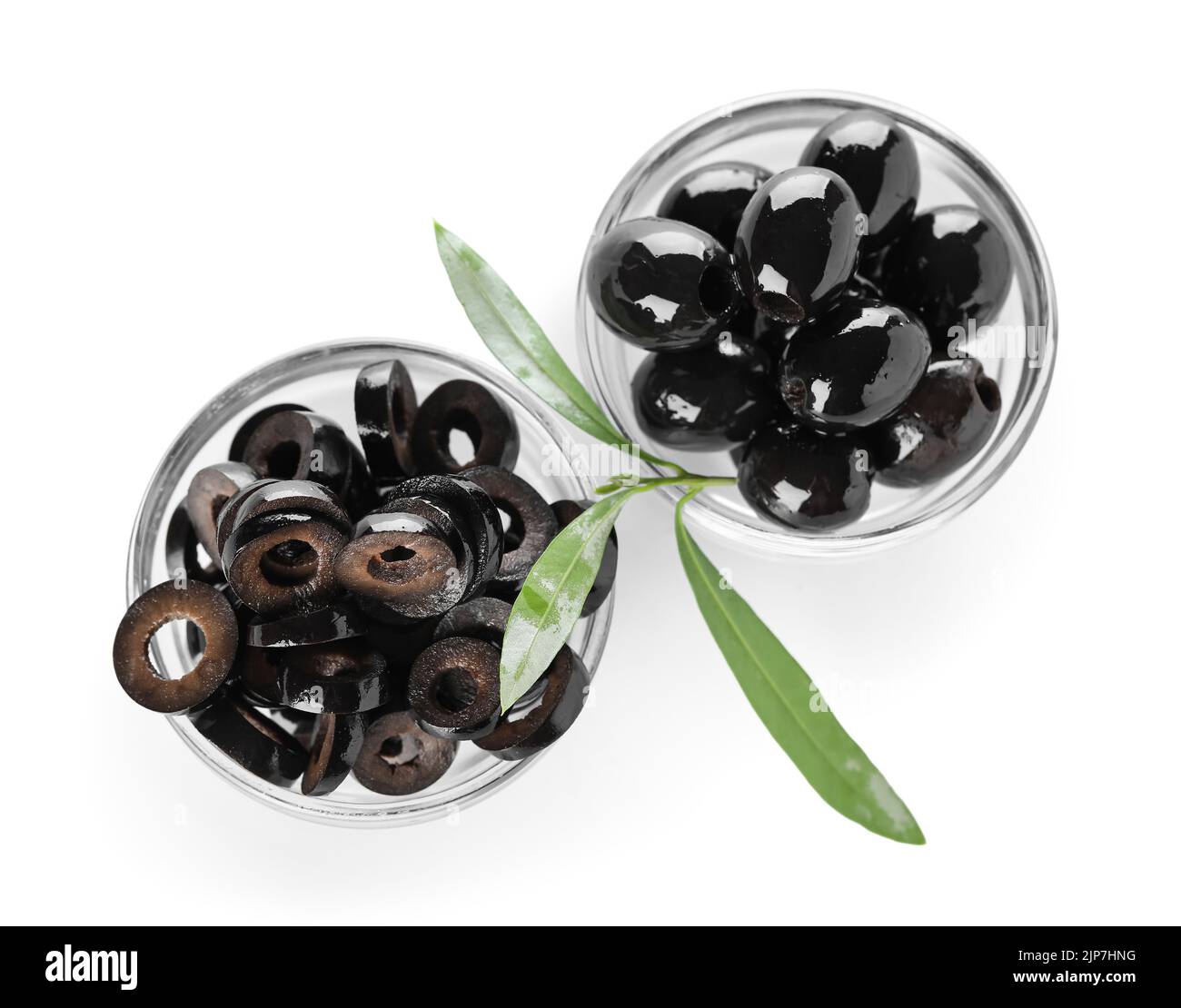 Glass bowls of cut and whole black olives on white background Stock ...