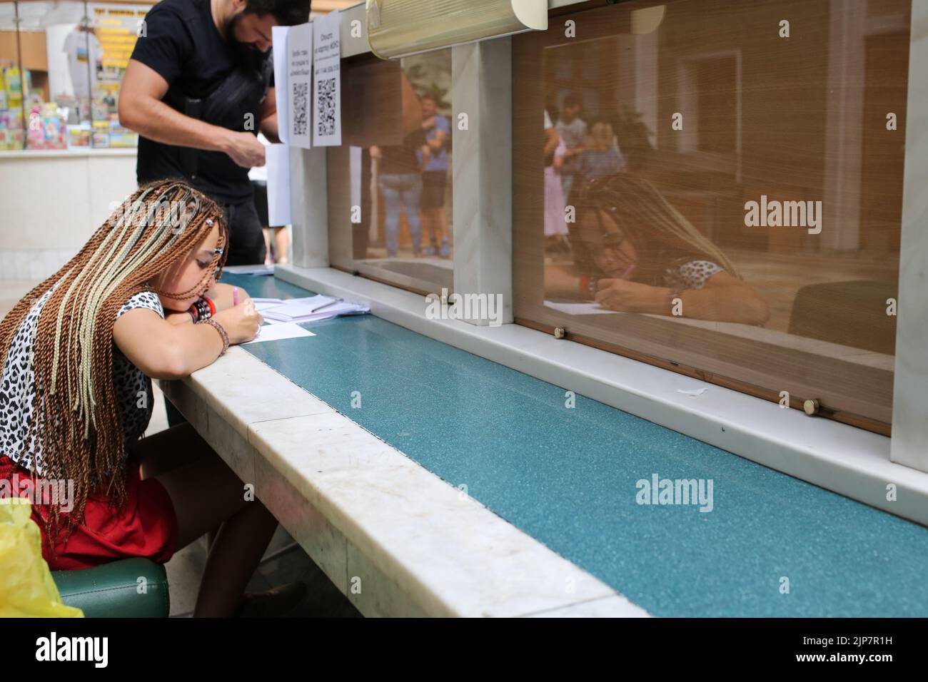 Odessa, Ukraine. 12th Aug, 2022. A young girl is seen writing a letter to the front. Letter to the front. Project from Ukrpochta (Ukrainian Post).Every large and small Ukrainian can express his gratitude to the modern heroes by sending a picture or a postcard to any branch of Ukrposhta. All children's drawings and postcards with words of support and hope for a peaceful life from adults and children will be given to military personnel in hot spots, as well as to medics and rescuers, representatives of ground defense, and communal services throughout the country. (Credit Image: © Viacheslav Ony Stock Photo