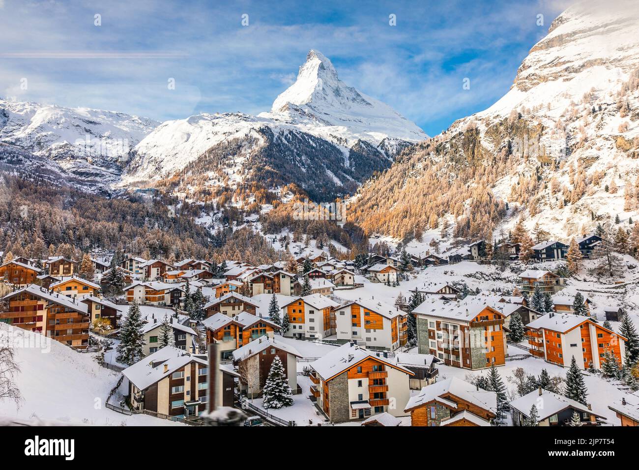 Zermatt, Switzerland - November 12, 2019: Aerial view of snowcapped village with background of iconic mountain peak Matterhorn, some hotels are closed Stock Photo