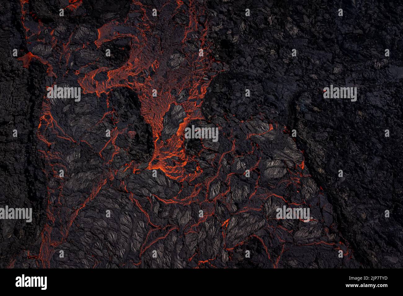 Magma flows from a heart shaped crater at the volcano in Fagradalsfjall ...