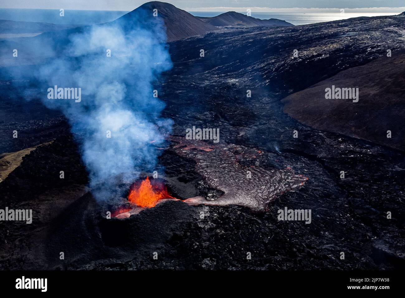 Magma flows from a heart shaped crater at the volcano in Fagradalsfjall ...