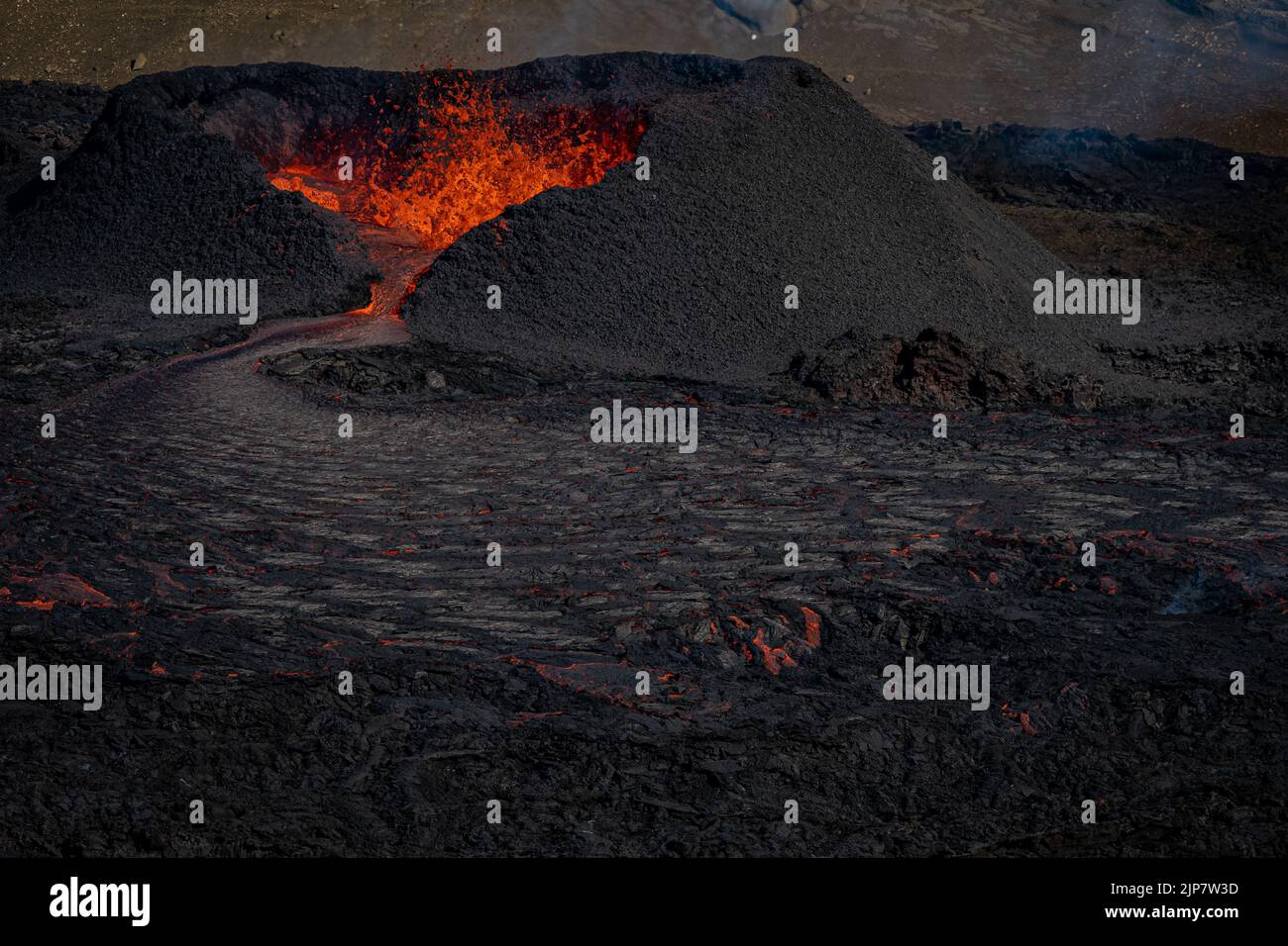 Magma flows from a heart shaped crater at the volcano in Fagradalsfjall ...