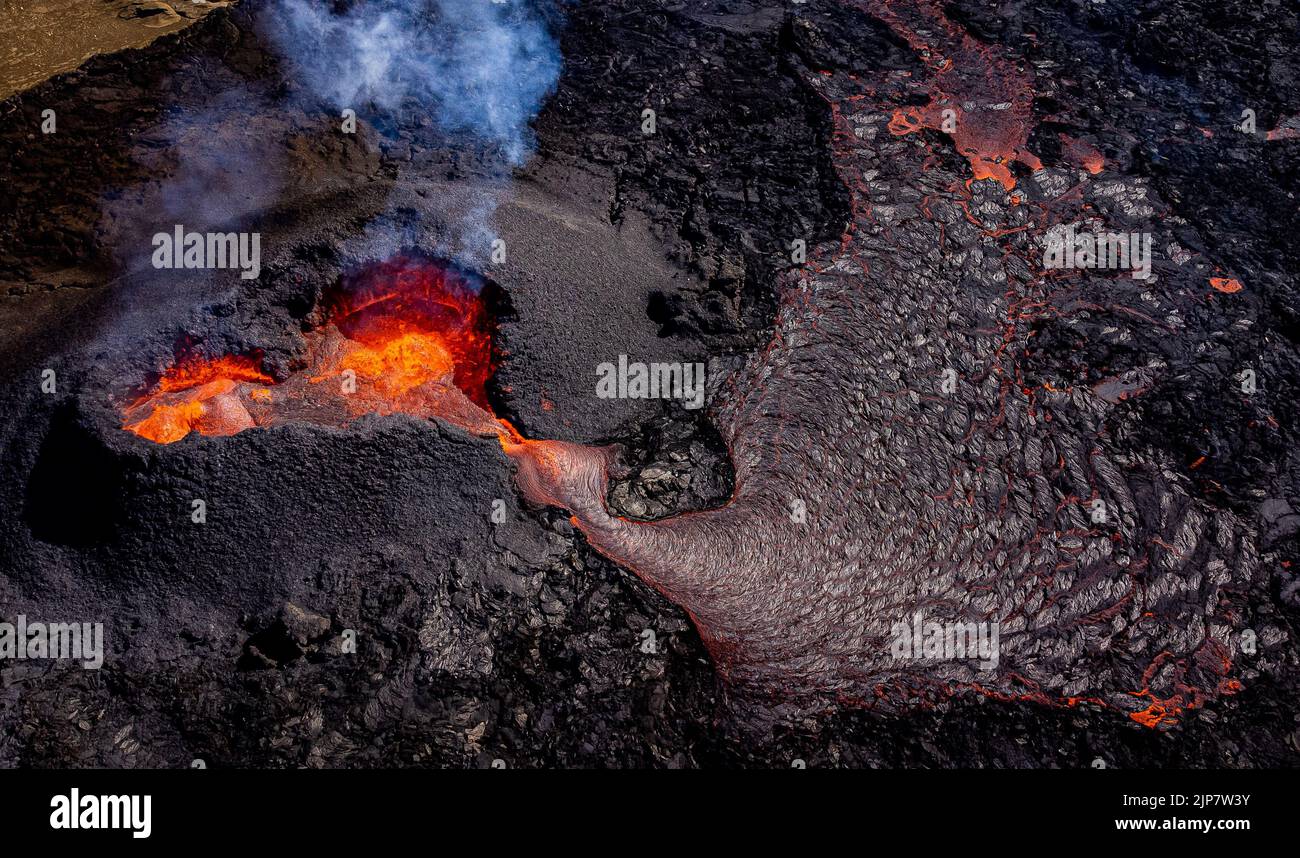 Magma flows from a heart shaped crater at the volcano in Fagradalsfjall ...