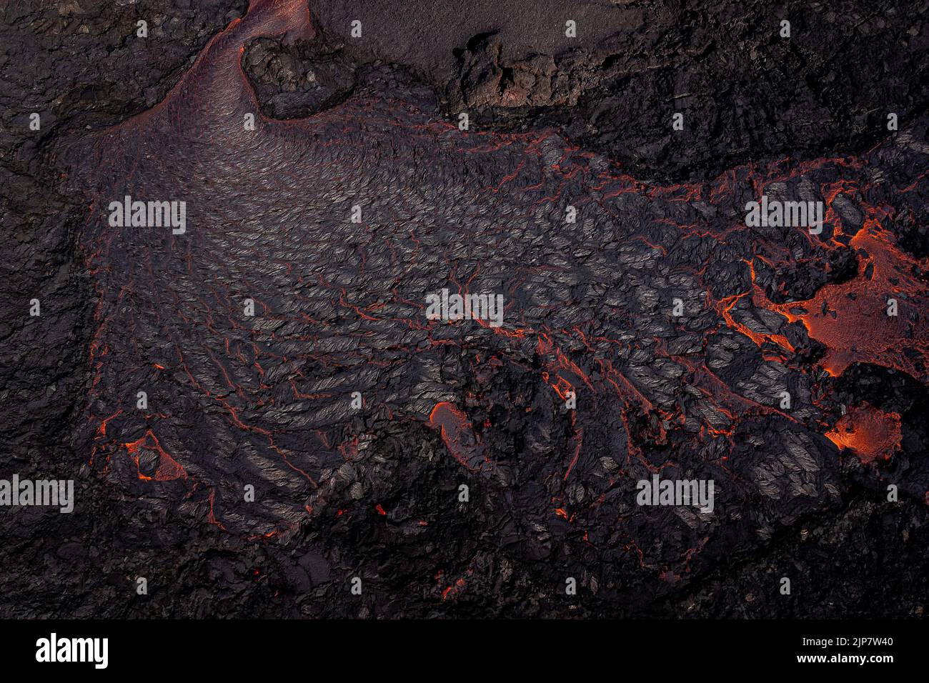 Magma flows from a heart shaped crater at the volcano in Fagradalsfjall ...