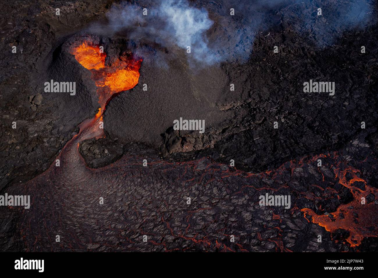 Magma flows from a heart shaped crater at the volcano in Fagradalsfjall ...
