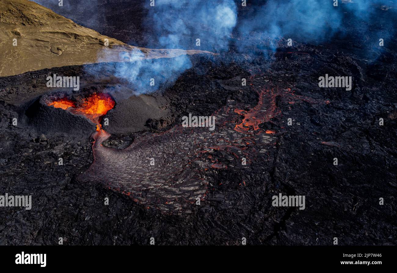 Magma flows from a heart shaped crater at the volcano in Fagradalsfjall ...
