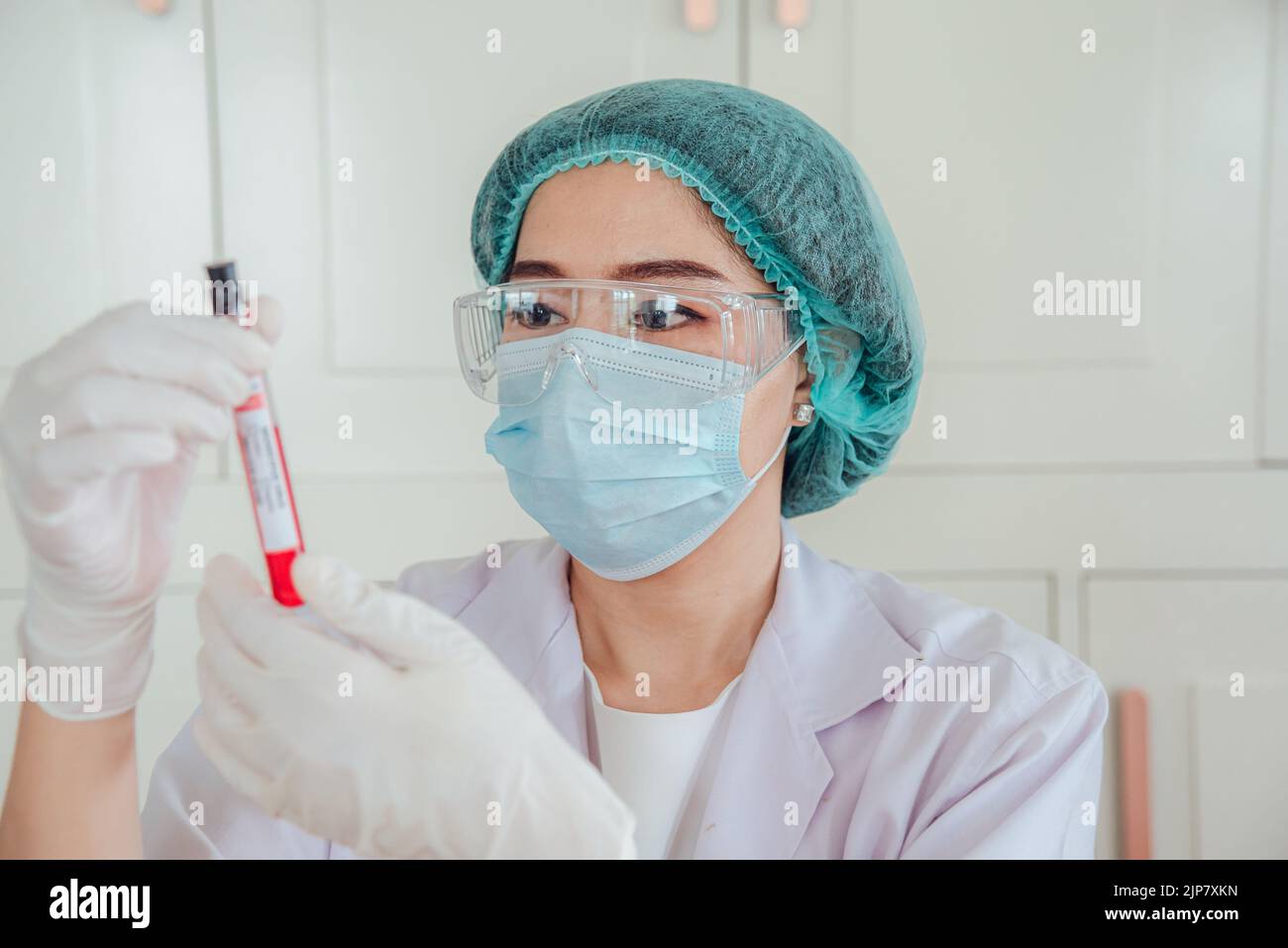 A doctor or scientist is holding an antigen blood testing tube for ...