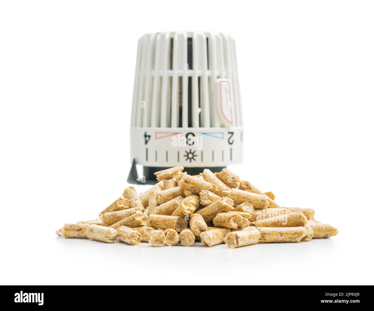 Wooden pellets and thermostatic valve head isolated on a white background. Biomass - Renewable source of heating. Stock Photo