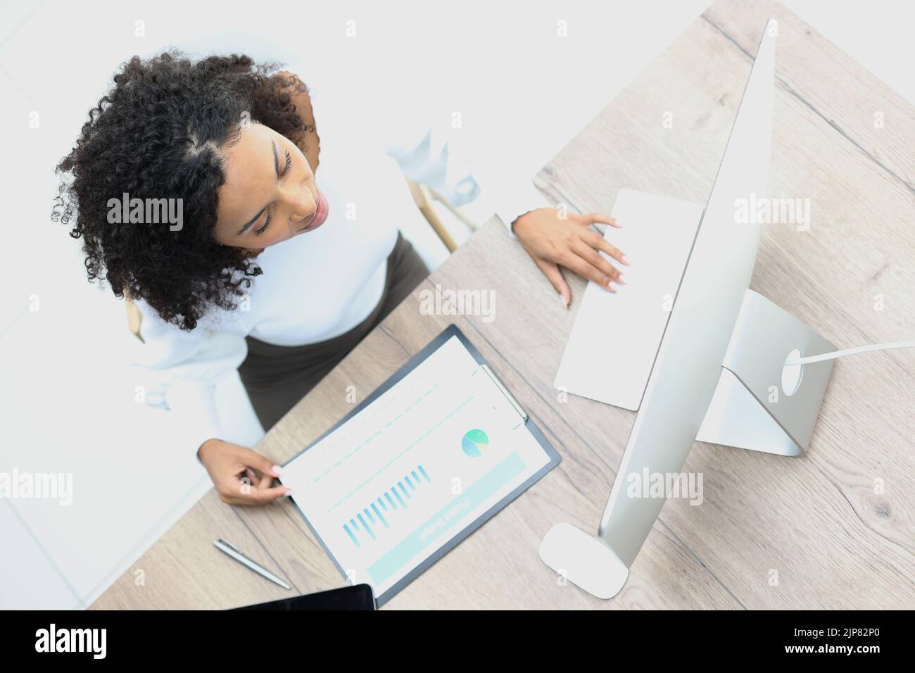 Young woman working at her office desk. top view Stock Photo