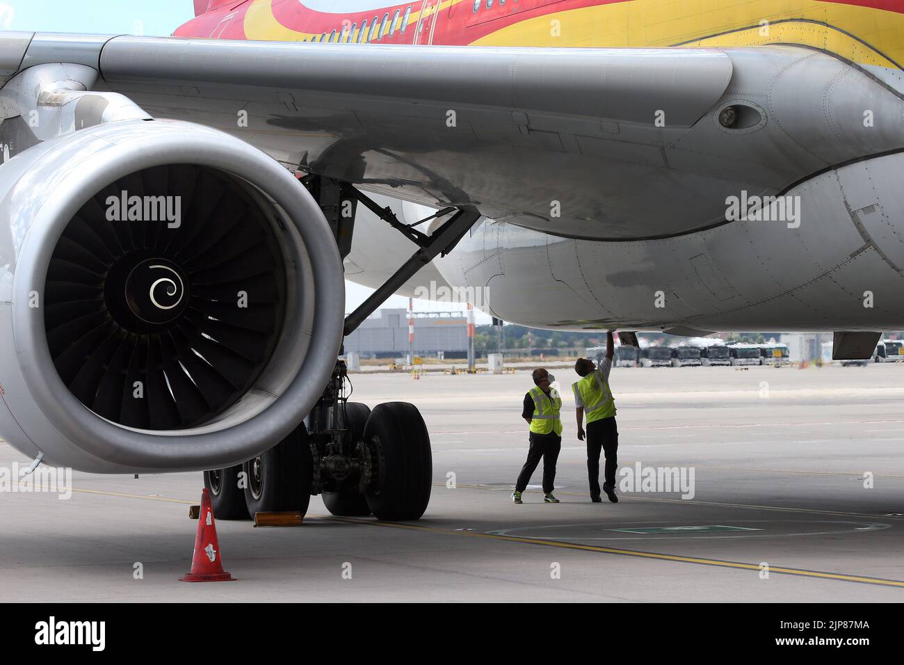 12 August 2022, Brandenburg, Schönefeld: Members of the crew inspect an Airbus A330-300 aircraft of the airline before the first flight of the Chinese airline Hainan from BER, at Berlin Brandenburg Airport. Photo: Wolfgang Kumm/dpa Stock Photo