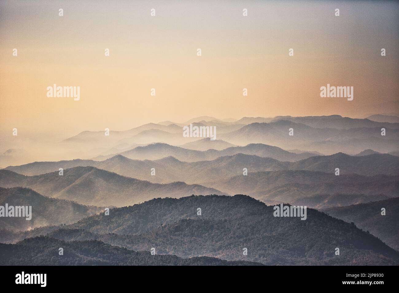 A breathtaking scenery of mountains covered with a layer of fog Stock ...