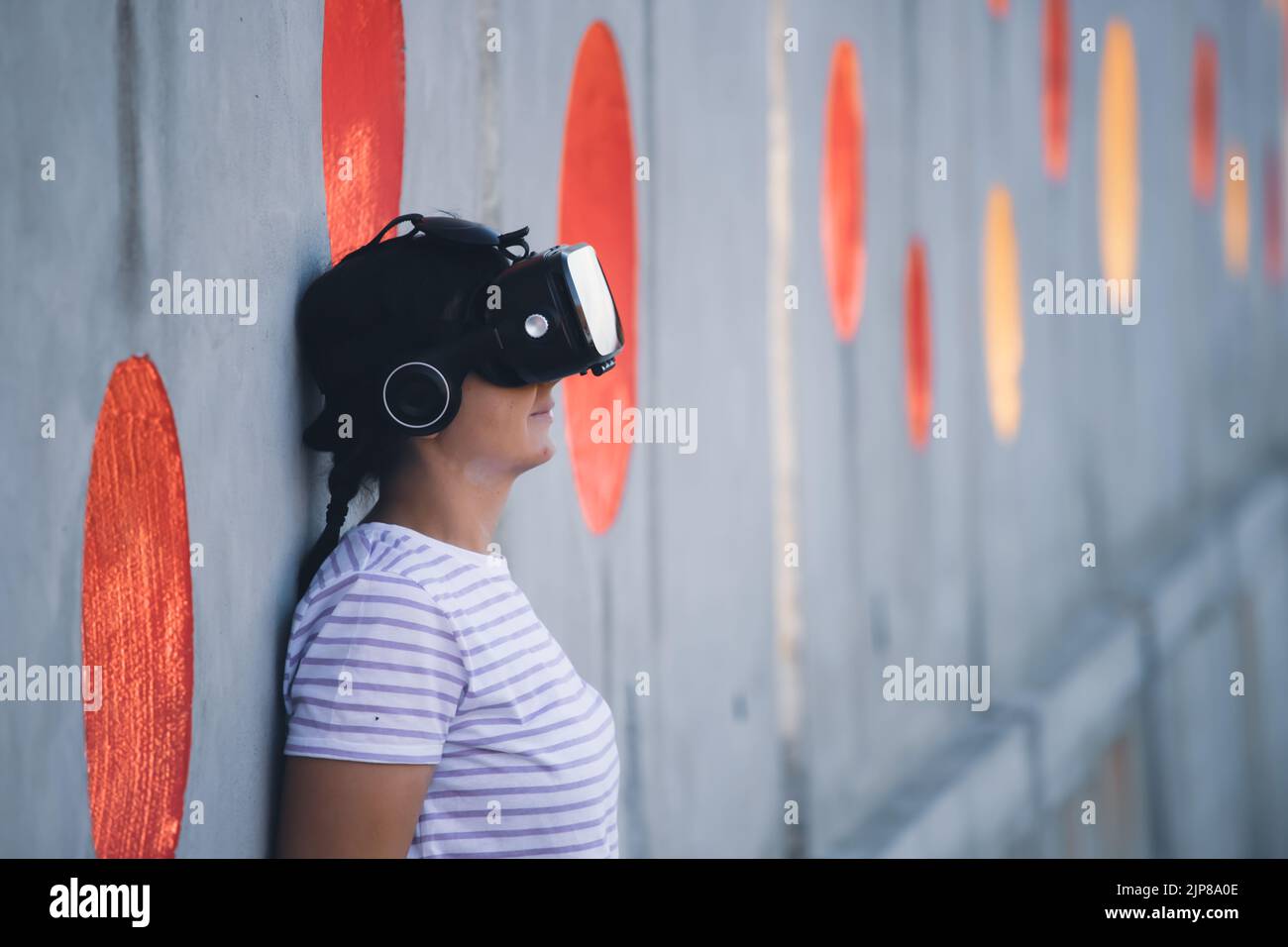 Woman wearing virtual reality goggles. Metaverse, technology, video game, futuristic concept Stock Photo