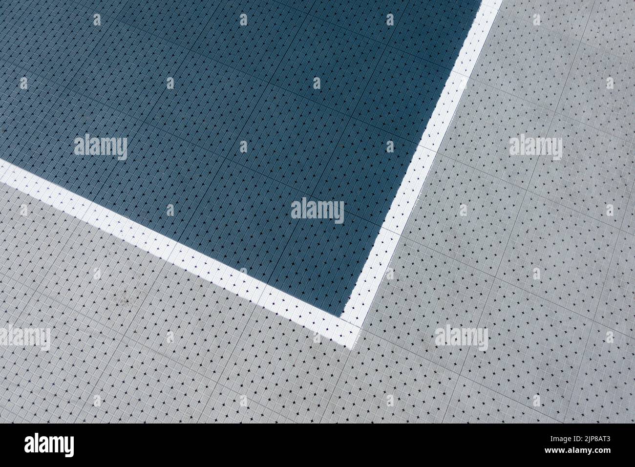 Gray color plastic covering of sports field, courtyard background. Basketball, volleyball ground