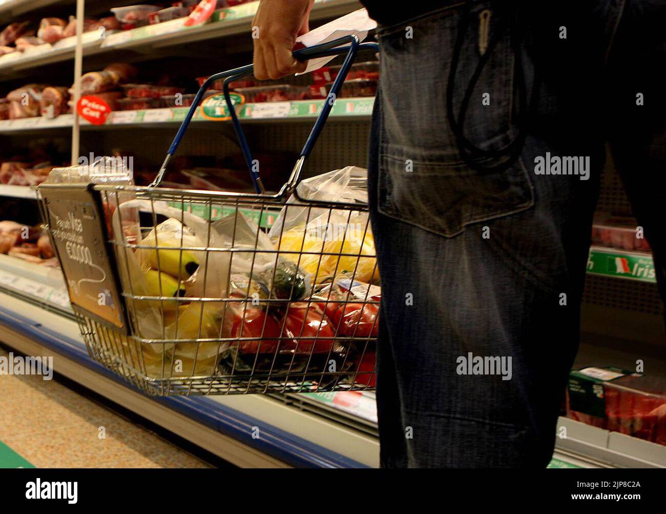 Undated file photo of a man holding a shopping basket in a supermarket. Shoppers have witnessed an 11.6% surge in grocery prices for the past month, the highest level since 2008, according to new figures. Research firm Kantar has said this equates to a £533 annual increase in the average household's grocery bill. Issue date: Tuesday August 16, 2022. Stock Photo