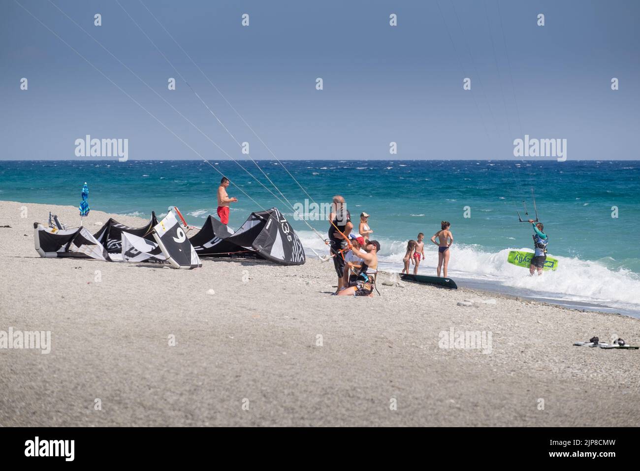 A man learning how to kite and kitesurf from the trainers in the shore of Agiokampos beach , Greece Stock Photo