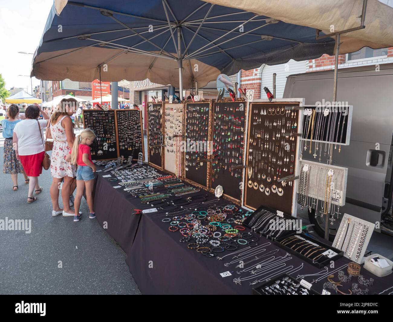 Sint Gillis Waas, Belgium, 06 August 2022, Mother and daughter look at the jewelery displayed in a market stall Stock Photo
