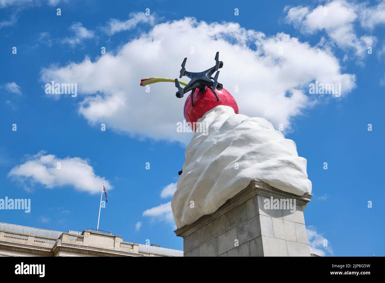 The whimsical, funny sculpture of a large dollop of whipped cream with a drone and fly attached to it. Titled, The End, by artist Heather Phillipson. Stock Photo