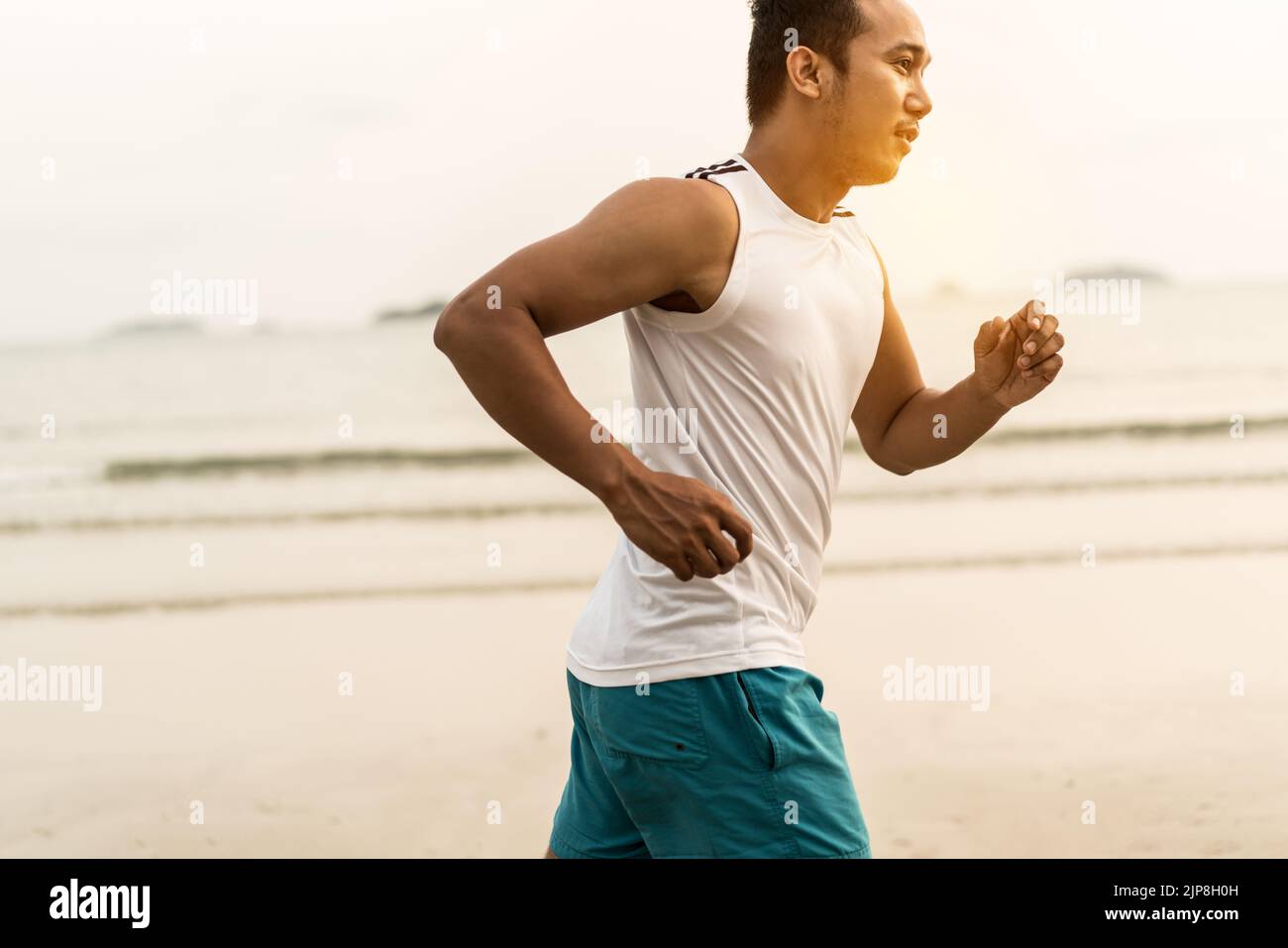 Young asian man jogging along hi-res stock photography and images - Alamy
