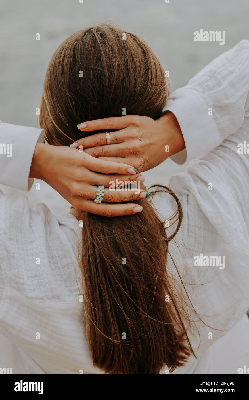 A beautiful shot of a woman tying her hair Stock Photo