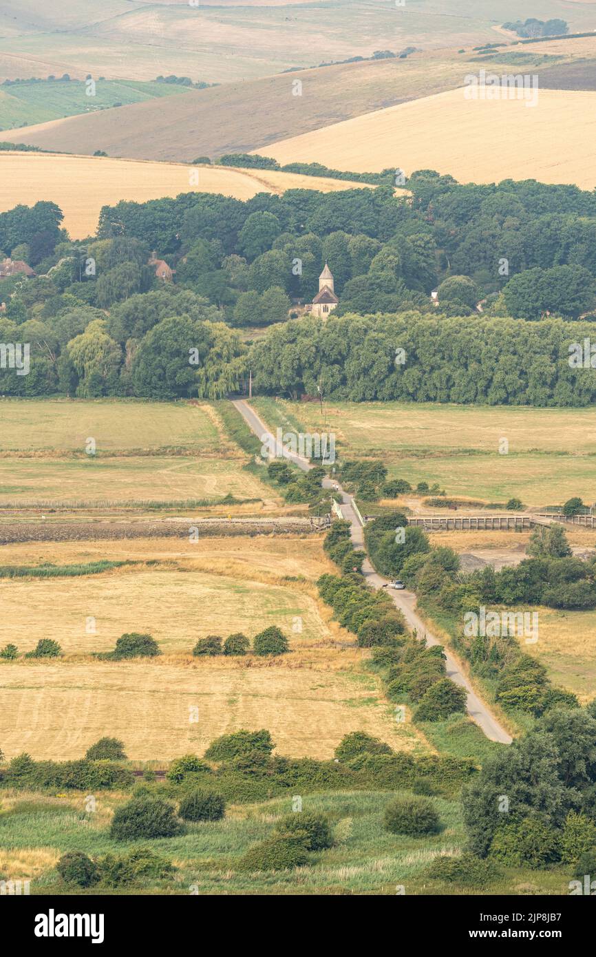 Track leading to a village in woodland Stock Photo