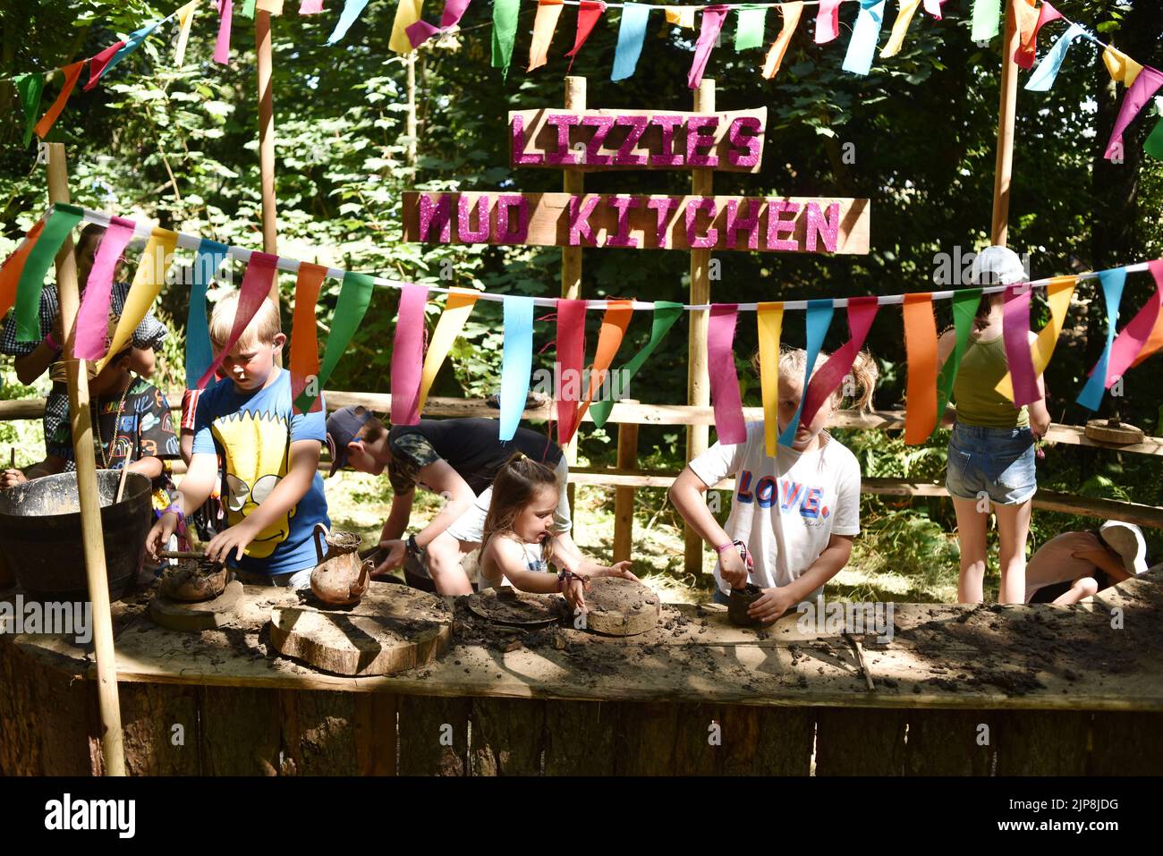 Kids playing in 'Lizzies Mud Kitchen' @ the family oriented festival Camp Bestival, Lulworth Castle and Estate, Dorset July 28 - 31 2022 Stock Photo