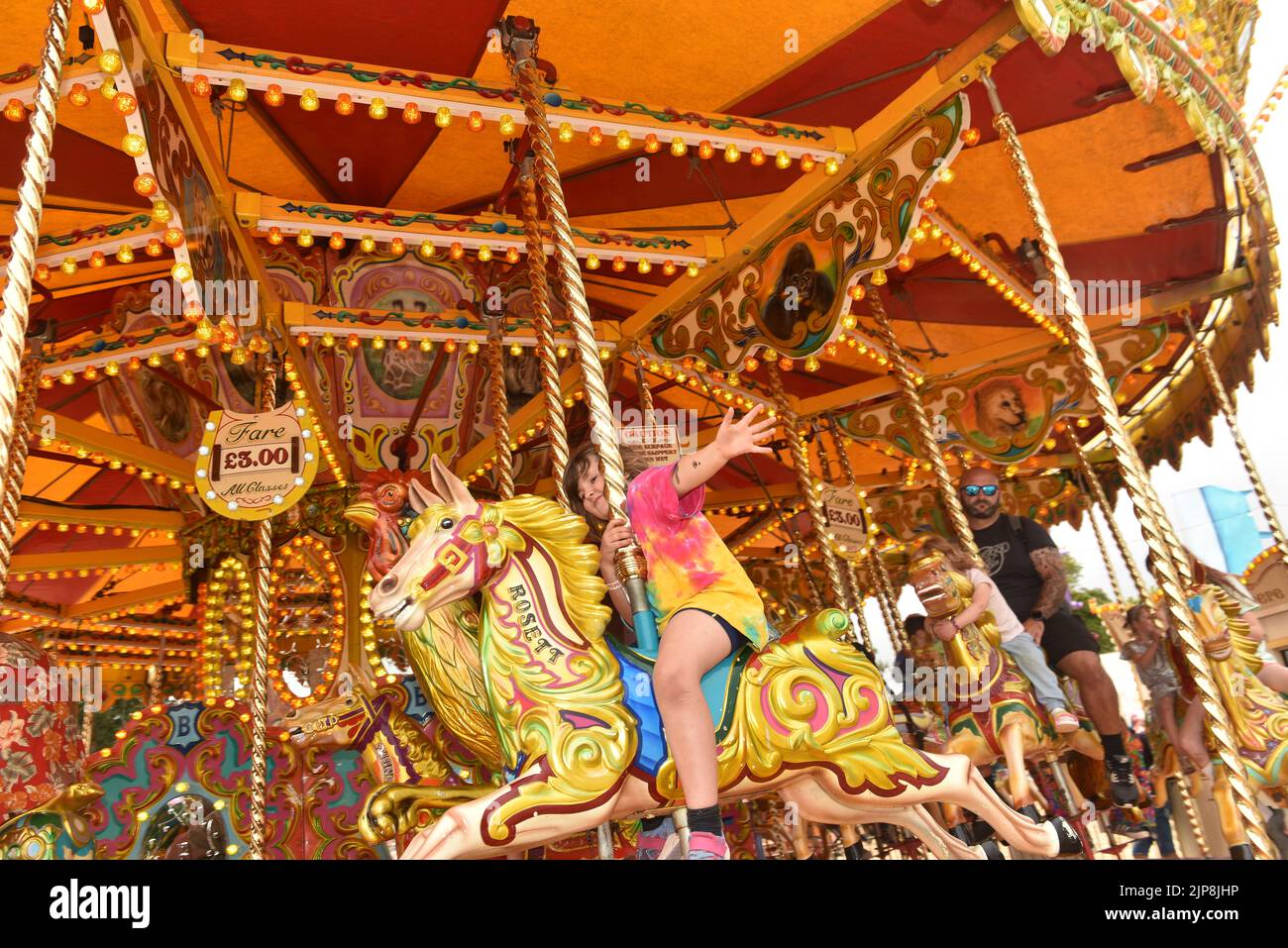A carousel, also known as a merry-go-round. Scenes at the family friendly festival Camp Bestival, Lulworth Castle and Estate, Dorset UK July 28 - 31 2022 Stock Photo