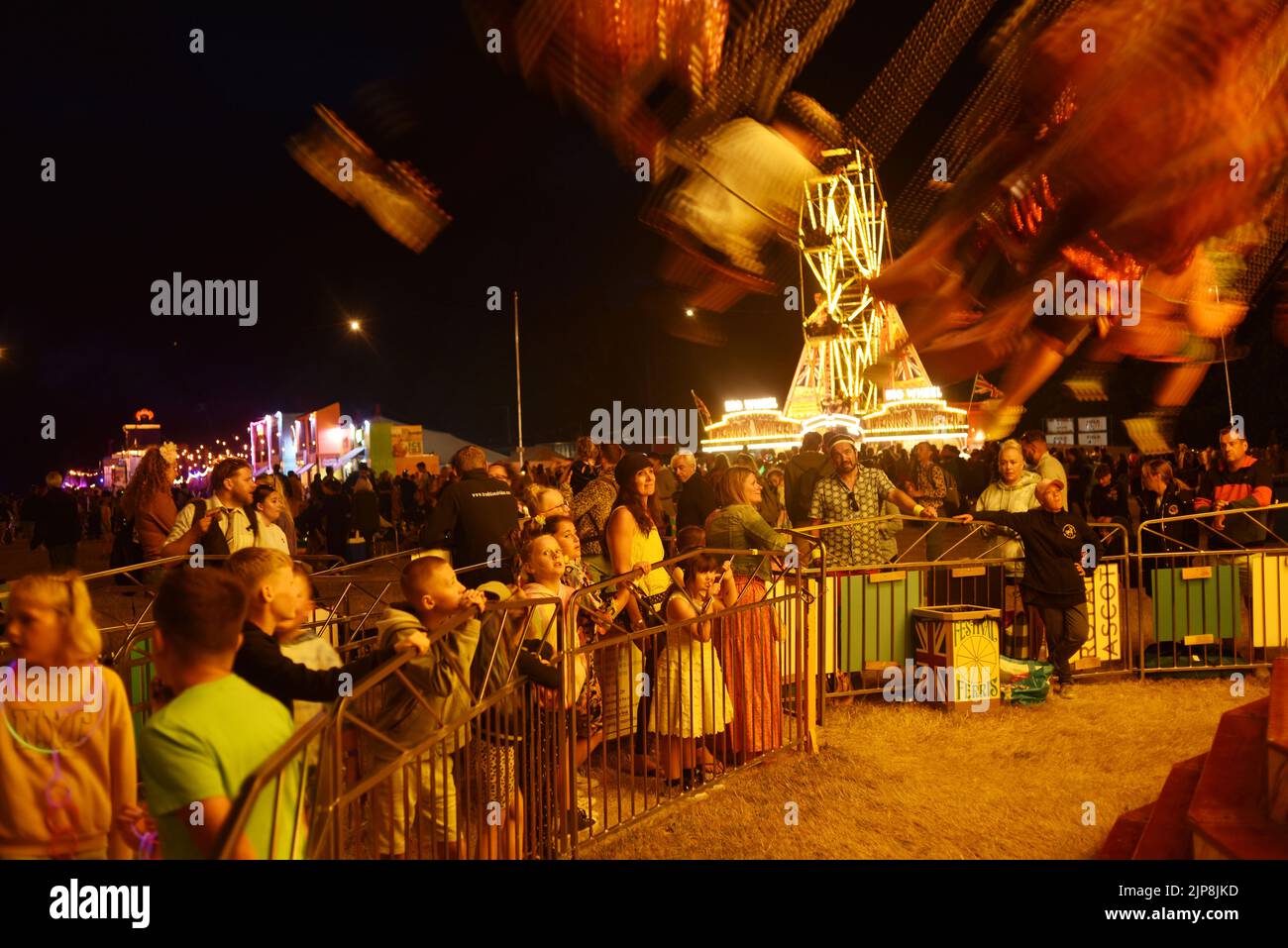 Crowds watch carousel swing ride at Camp Bestival, Lulworth Castle and Estate, Dorset July 28 - 31 2022 Stock Photo