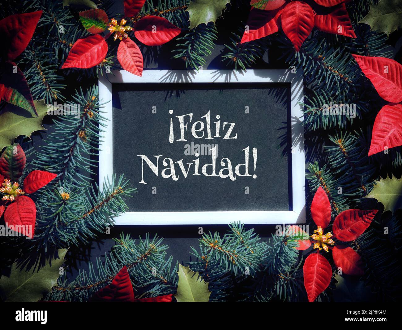 Feliz Navidad is Merry Christmas in Spanish language. Christmas festive background in red, black 