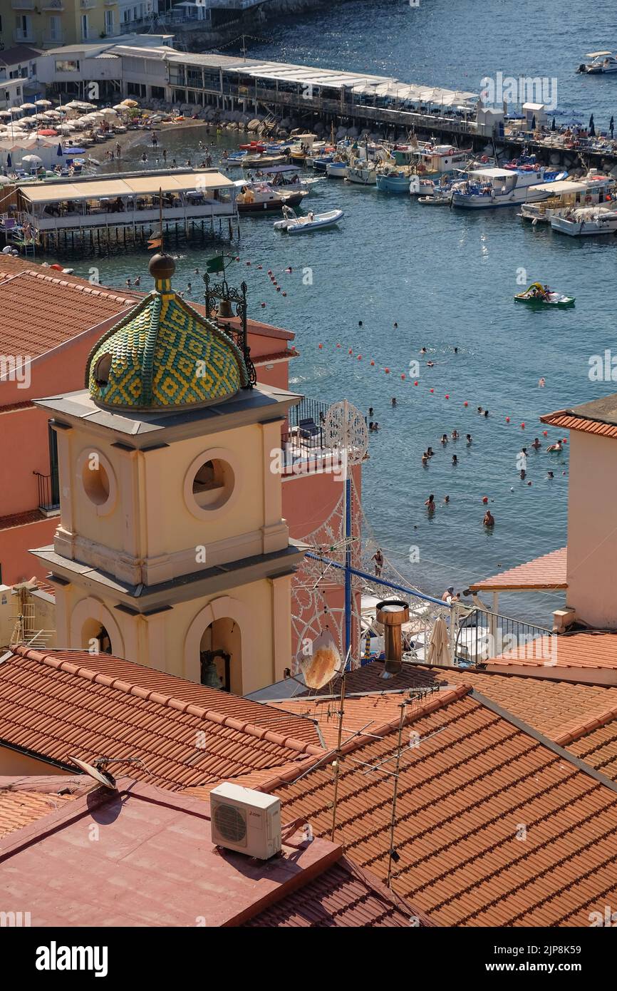A view of Marina Grande from the above hill with Chiesa di Sant'Anna cupola in the foreground and the beach and harbour behind. Stock Photo