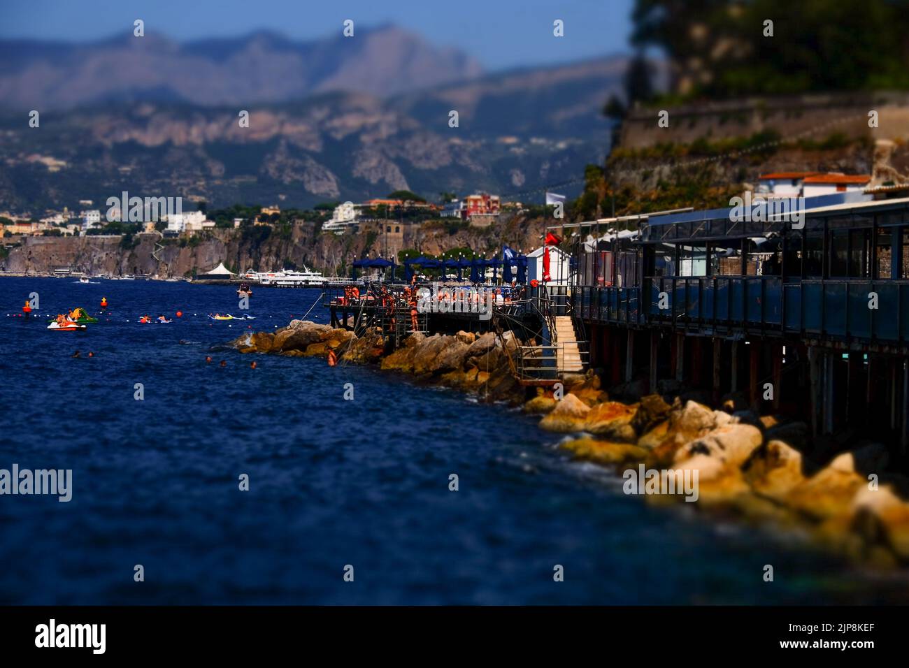 A private coastal beach club near Marina Grande in Sorrento southern Italy with the Lattari mountains and Sorrento peninsular  in the background. Stock Photo