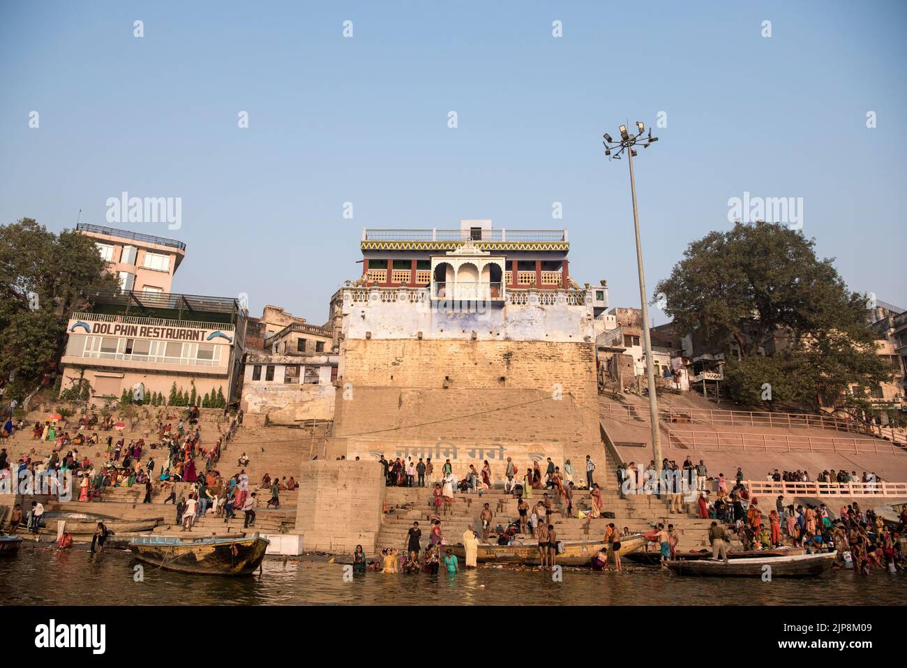 People bathing at Manmandir Ghat, Dolphin restaurant, Varanasi, Banaras, Benaras, Kashi, Uttar Pradesh, India Stock Photo
