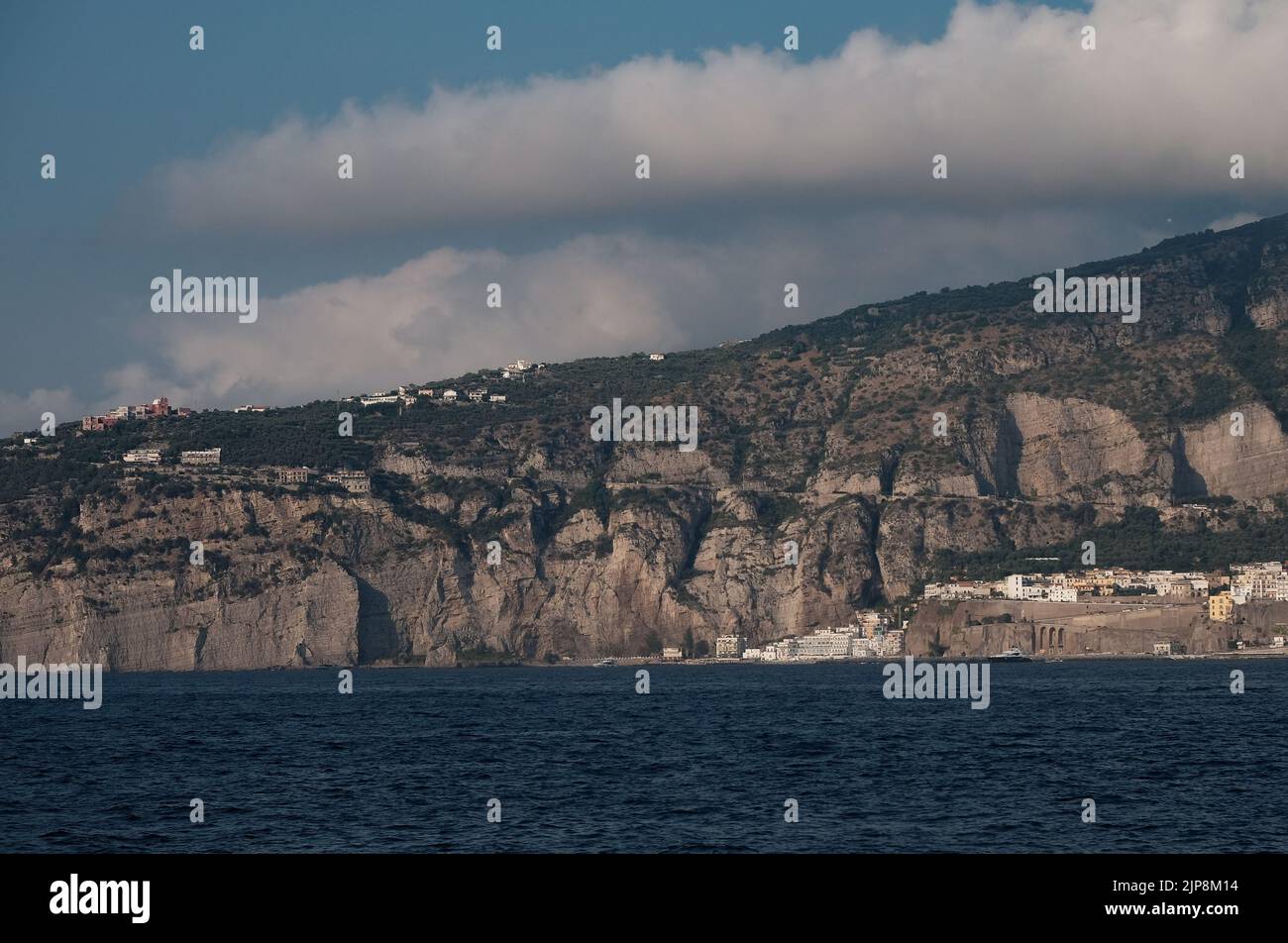 View of part of the Sorrento peninsula with building perched on top looking out into the Bay of Naples. Stock Photo