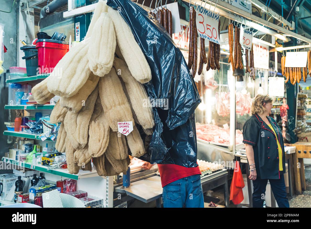 01.15.2021 Thessaloniki, Greece. Greek sellers stanting at their stalls, presenting variety of meat or other products such as natural sponges. High quality photo Stock Photo