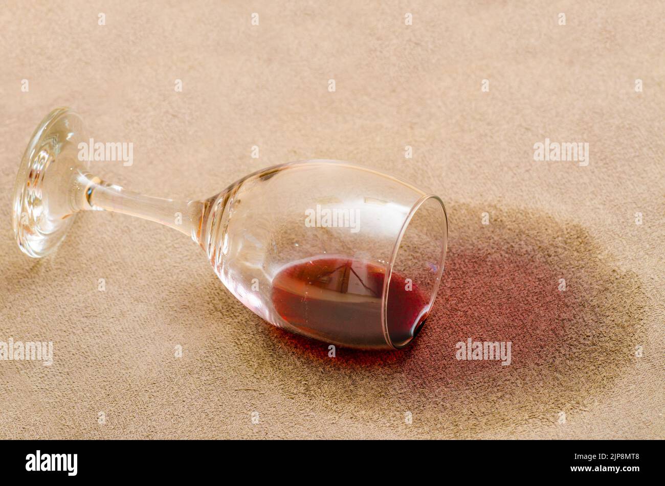 Red wine stain on a carpet inside a living room Stock Photo Alamy