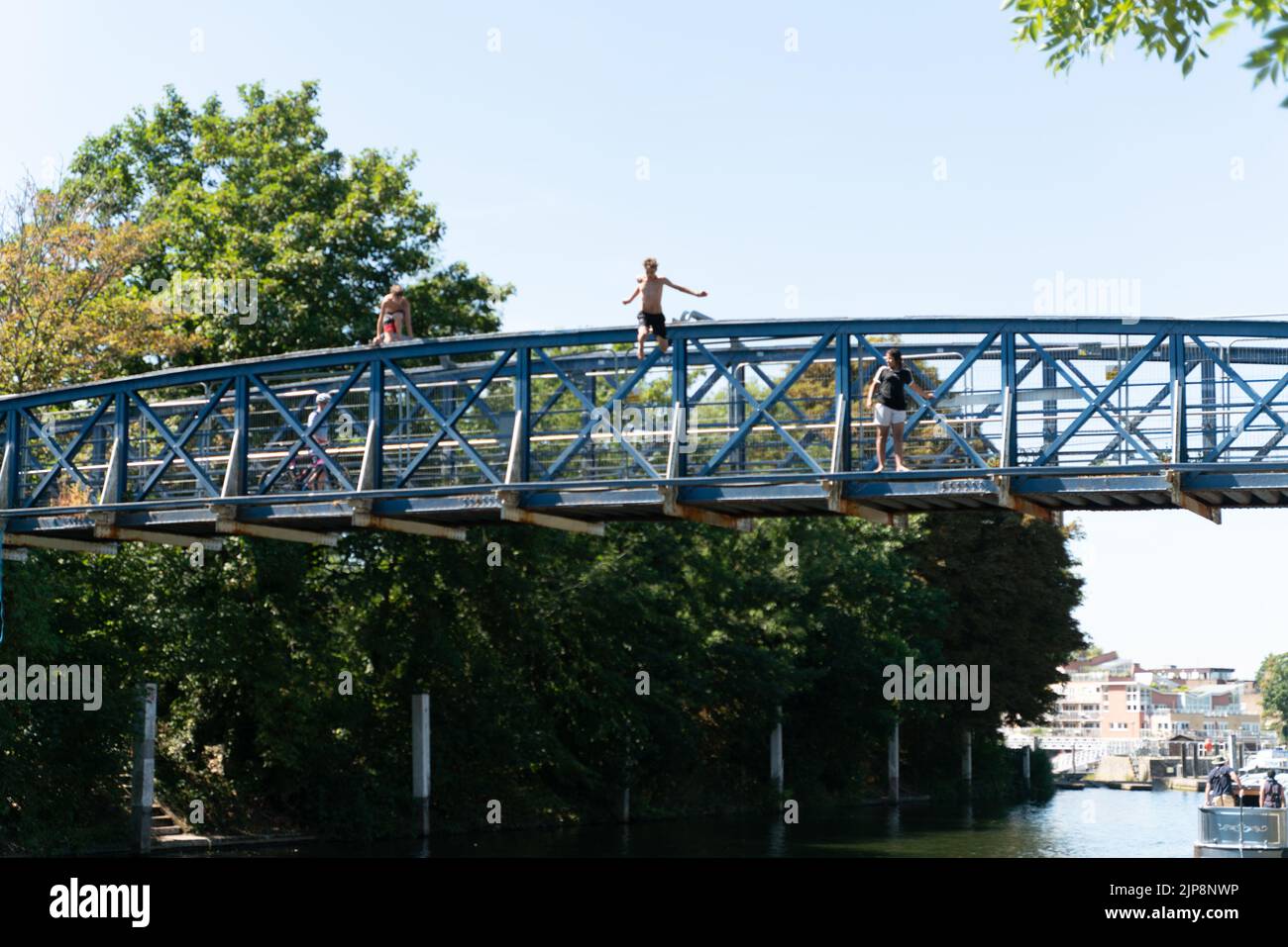 Boy Jumping From Bridge Stock Photo