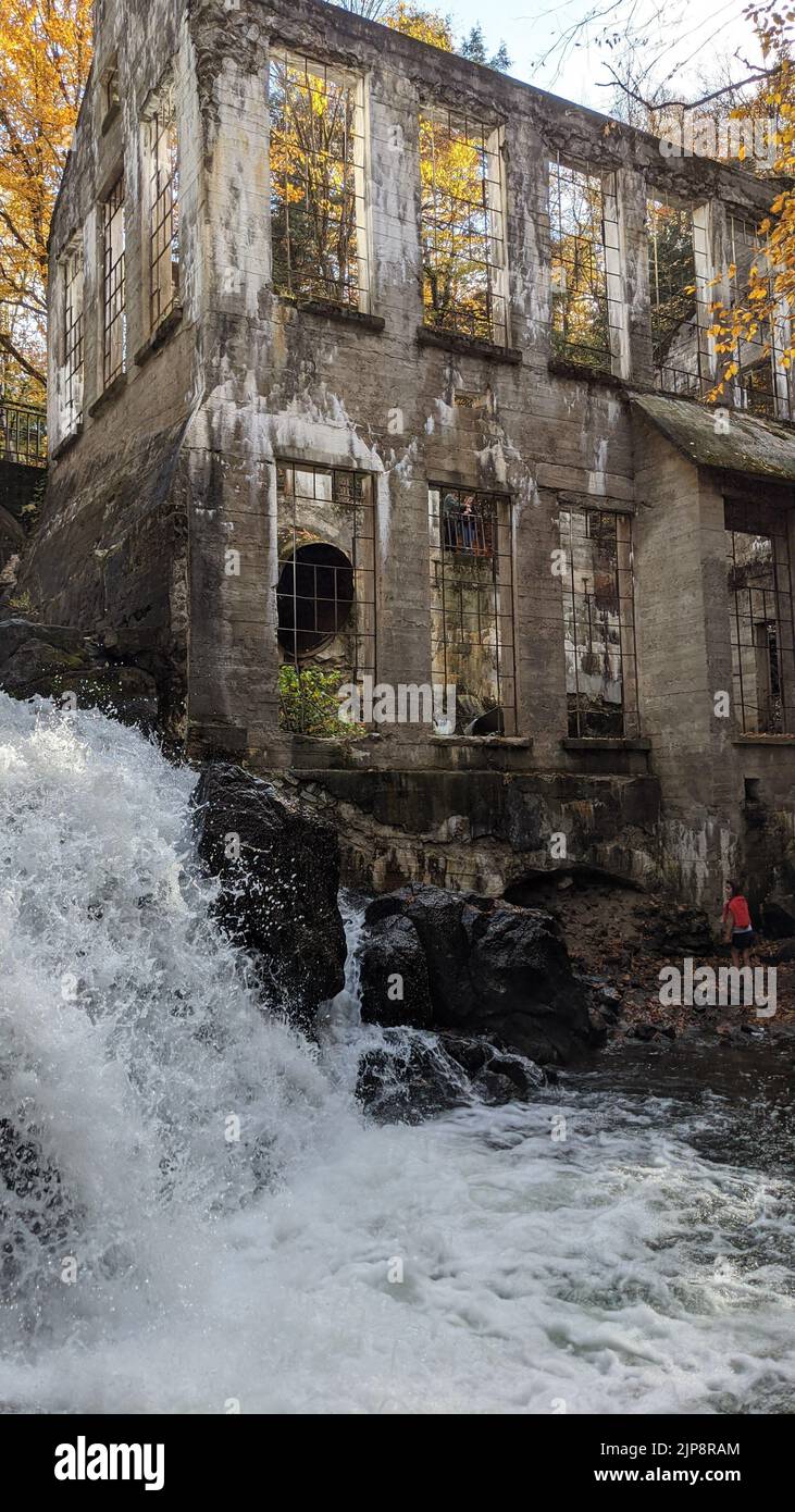 A vertical shot of Carbide Willson Ruins near a waterfall in Chelsea, Canada Stock Photo