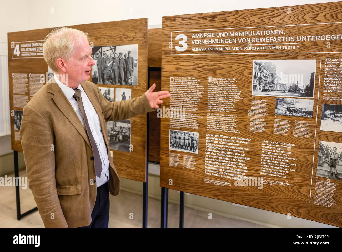 16 August 2022, Schleswig-Holstein, Schleswig: Rainer Hering, Senior Archive Director of the Schleswig-Holstein State Archives, speaks in front of an information panel. On August 17, 2022, the exhibition "Heinz Reinefarth. From Nazi War Criminal to Member of the State Parliament" will open. Reinefarth was a German lieutenant general in the Waffen SS and was responsible for, among other things, the suppression of the Warsaw Uprising, during which tens of thousands of civilians were shot under his command. Reinefarth was never prosecuted for his actions. He managed to embark on a political caree Stock Photo