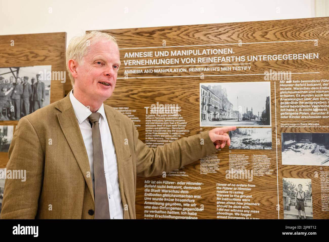 16 August 2022, Schleswig-Holstein, Schleswig: Rainer Hering, Senior Archive Director of the Schleswig-Holstein State Archives, speaks in front of an information panel. On August 17, 2022, the exhibition "Heinz Reinefarth. From Nazi War Criminal to Member of the State Parliament" will open. Reinefarth was a German lieutenant general in the Waffen SS and was responsible for, among other things, the suppression of the Warsaw Uprising, during which tens of thousands of civilians were shot under his command. Reinefarth was never prosecuted for his actions. He managed to embark on a political caree Stock Photo