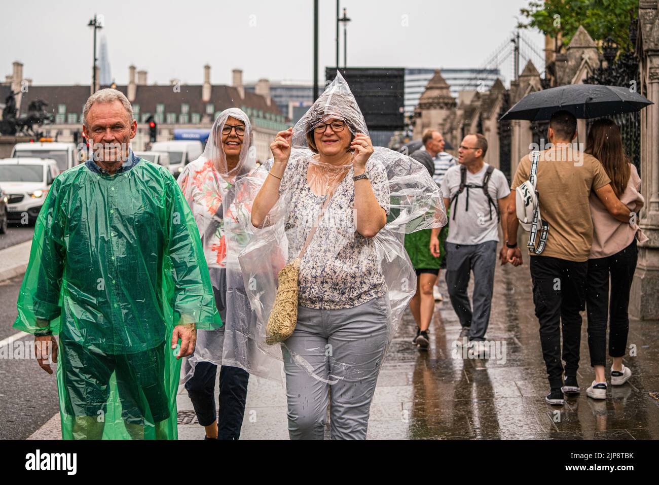Westminster London, UK. 16 August 2022 . Tourists wearing rain pponchos walk on Westminster bridge  during rain showers as the drought ends  after the prolonged dry spell and the driest summer in 46 years as the met office issues a yellow warning for thunderstorms and flash floods . Credit. amer ghazzal/Alamy Live News Stock Photo