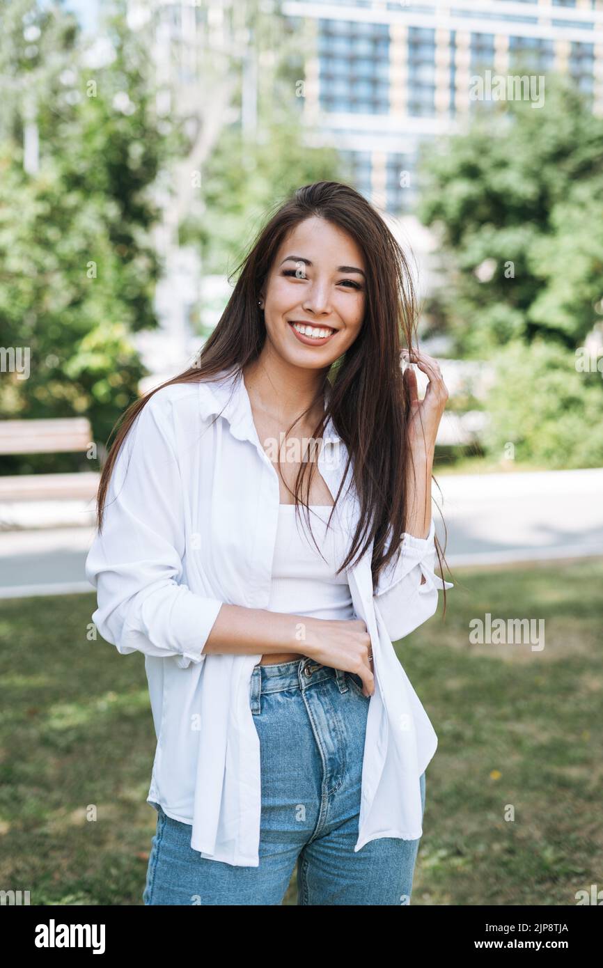 Portrait of young asian woman student with long hair in city park Stock ...