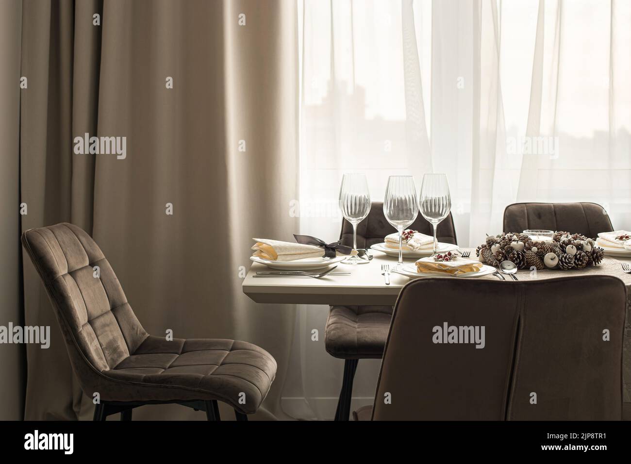 Served table in modern dining room. Interior design details close-up. Stock Photo
