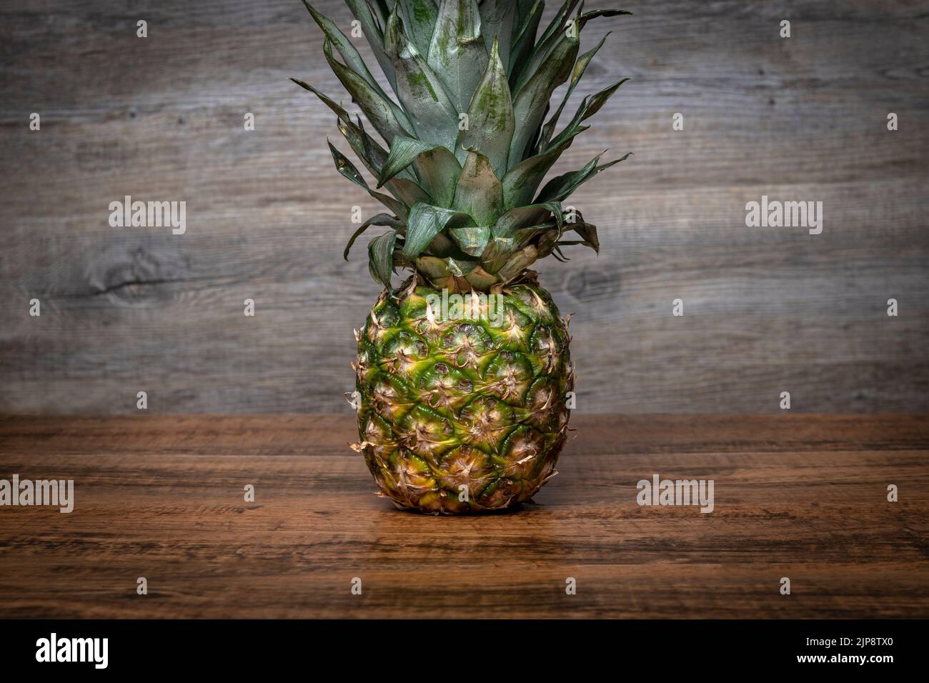 Pineapple on a wooden table Stock Photo