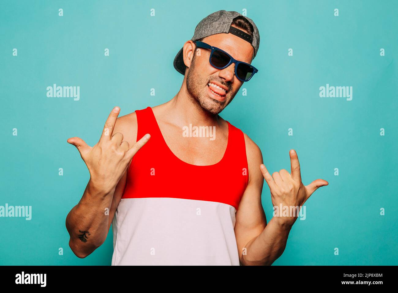 self confident, sticking out tongue, mano cornuta, rock and roll, self confidents, poking tongues, sticking out tongues Stock Photo