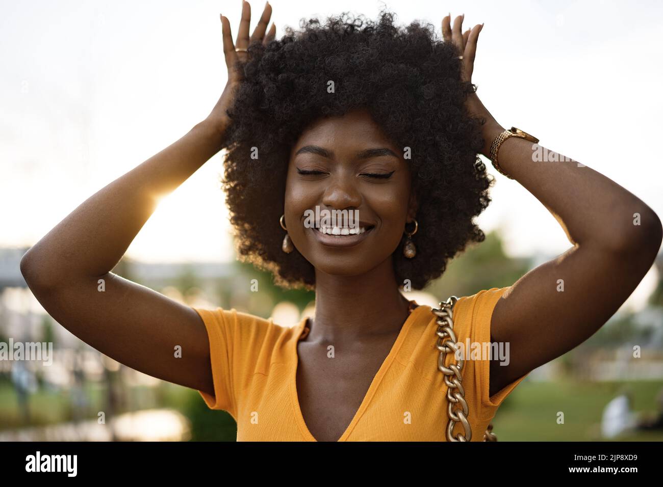 Portrait of a young african american woman smiling standing at the city ...